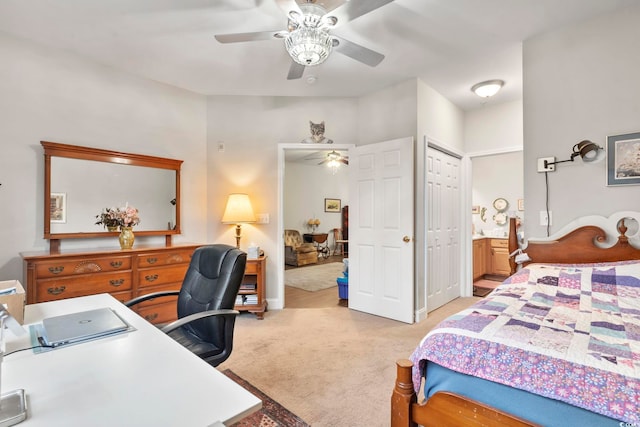 bedroom featuring a closet, light carpet, ceiling fan, and ensuite bathroom