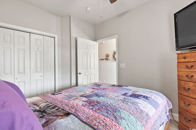 carpeted bedroom featuring a closet and a ceiling fan