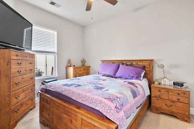 bedroom featuring light colored carpet, visible vents, and ceiling fan