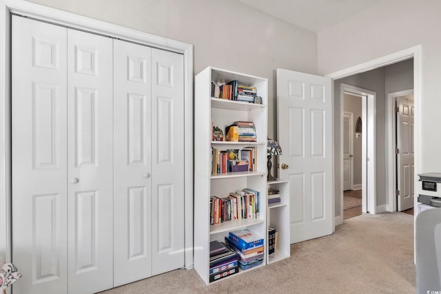 interior space with carpet floors and baseboards