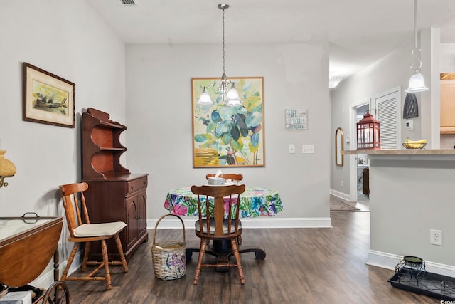 dining space with dark wood-style flooring, visible vents, and baseboards