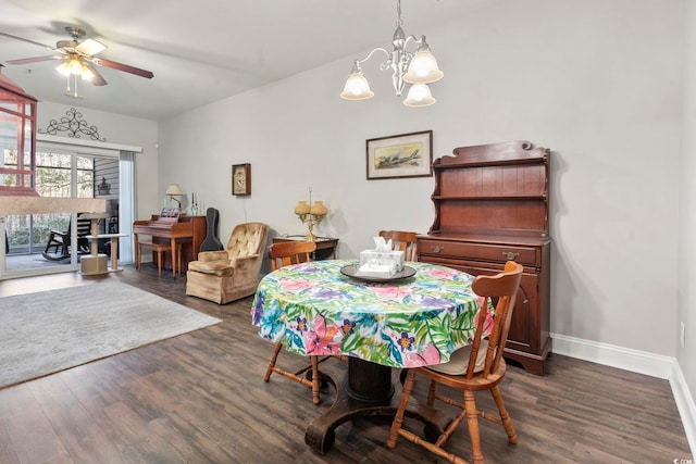 dining area with dark wood-style floors, baseboards, and ceiling fan with notable chandelier