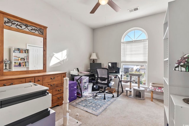 home office with ceiling fan, carpet floors, plenty of natural light, and visible vents