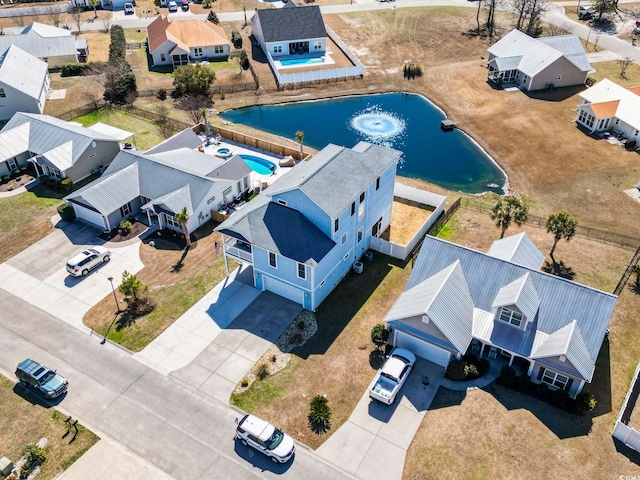 bird's eye view with a water view and a residential view