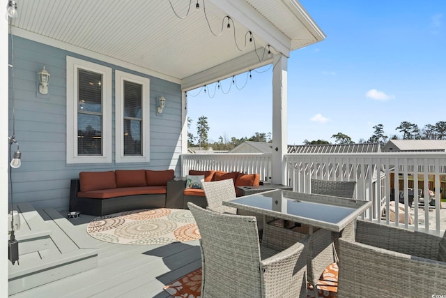 deck featuring outdoor dining space and an outdoor living space