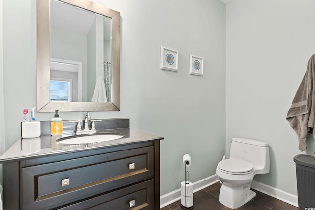 full bath with tile patterned floors, vanity, toilet, and baseboards