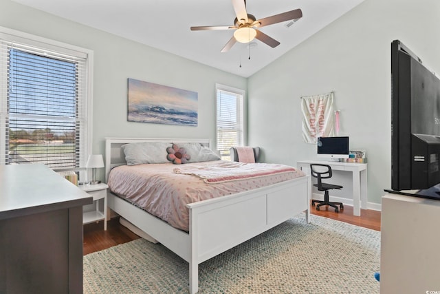 bedroom with lofted ceiling, wood finished floors, a ceiling fan, and baseboards