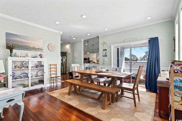 dining space featuring recessed lighting, crown molding, and wood finished floors