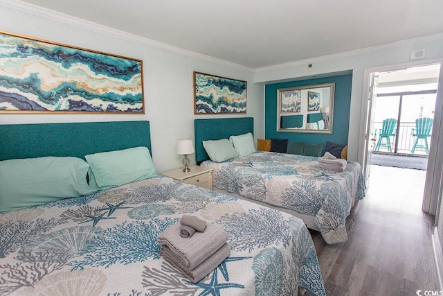 bedroom with ornamental molding and wood finished floors