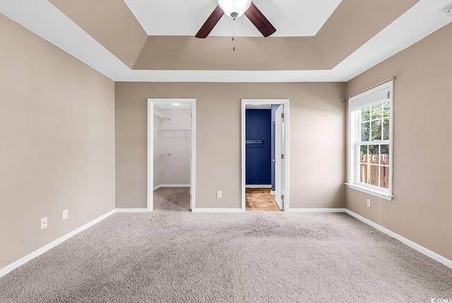 206 Balsa Dr, Longs, SC 29568 - unfurnished bedroom featuring a raised ceiling, carpet flooring, a spacious closet, a closet, and ceiling fan