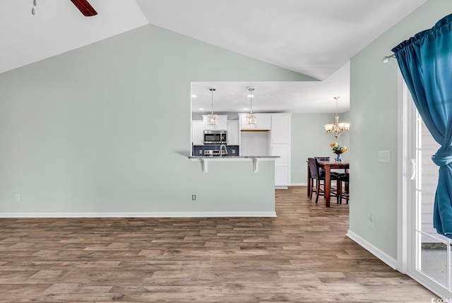 206 Balsa Dr, Longs, SC 29568 - living room with lofted ceiling, wood finished floors, a chandelier, and ceiling fan