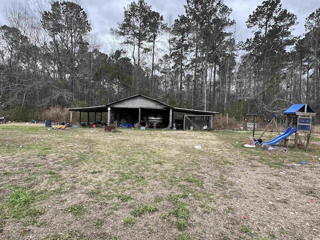 view of yard featuring an outbuilding and a playground