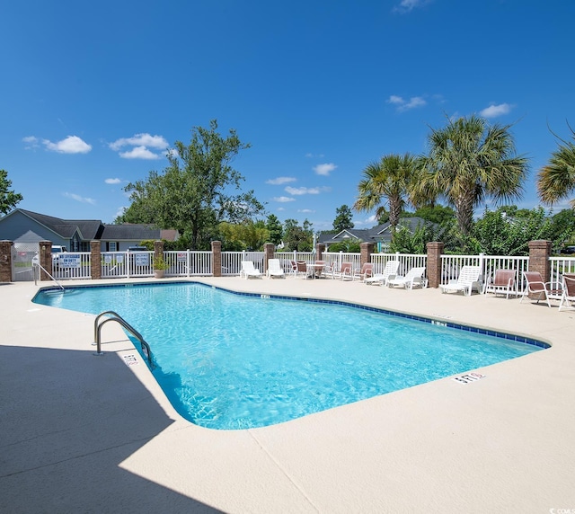 pool featuring a patio area and fence