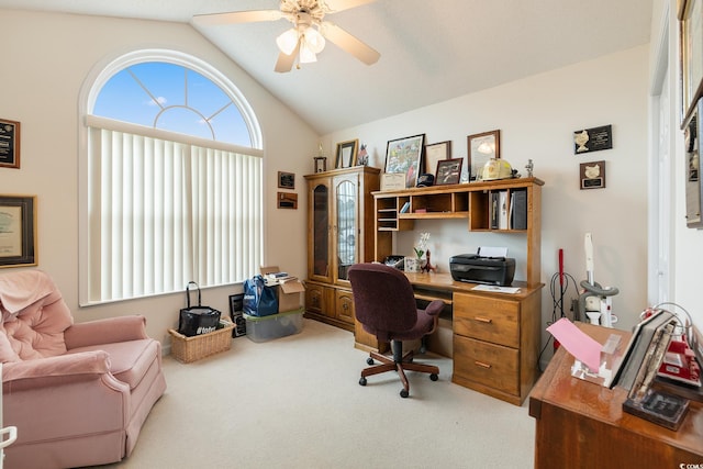 carpeted office space featuring vaulted ceiling and ceiling fan