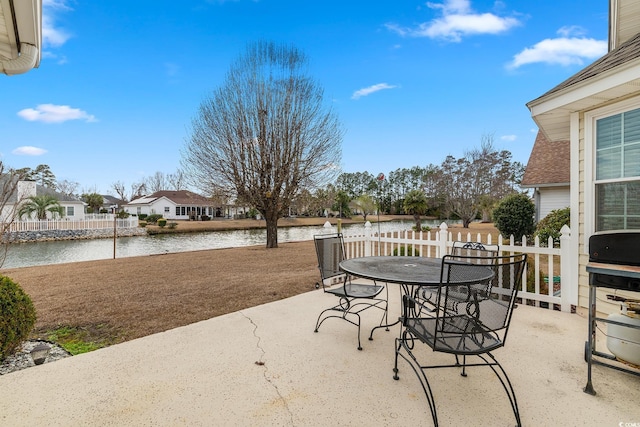 view of patio / terrace with outdoor dining space and a water view