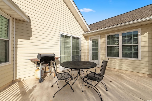 view of patio featuring outdoor dining area and a grill