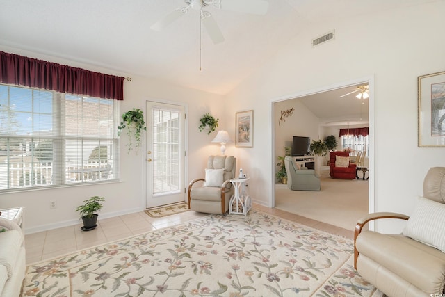 sitting room featuring visible vents, vaulted ceiling, ceiling fan, tile patterned flooring, and baseboards