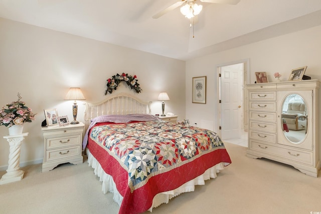 bedroom with a ceiling fan and light colored carpet