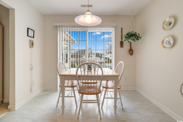 dining area featuring visible vents and baseboards