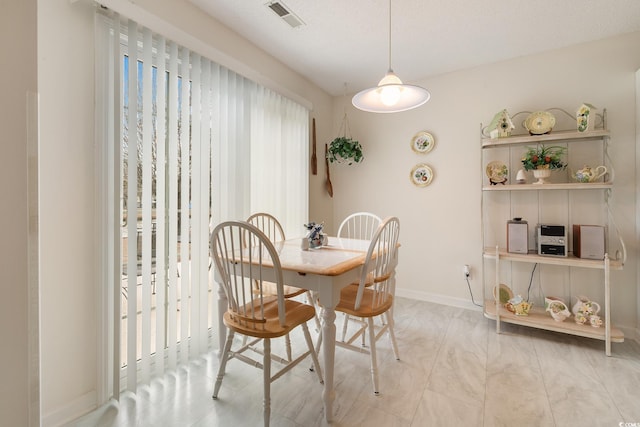 dining area featuring visible vents and baseboards