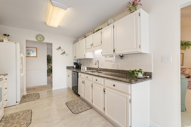 kitchen with white cabinets, dishwasher, backsplash, freestanding refrigerator, and a sink