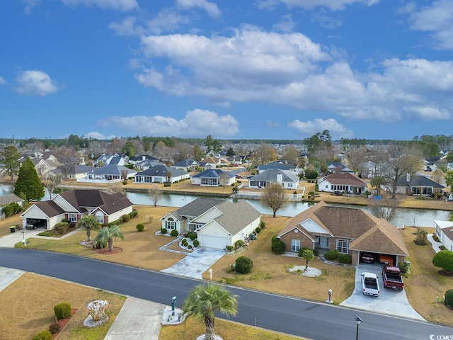 drone / aerial view featuring a residential view and a water view