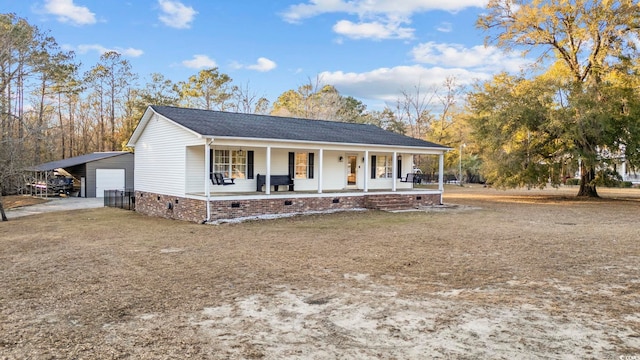 view of front of house featuring a porch, an outbuilding, crawl space, and a detached garage