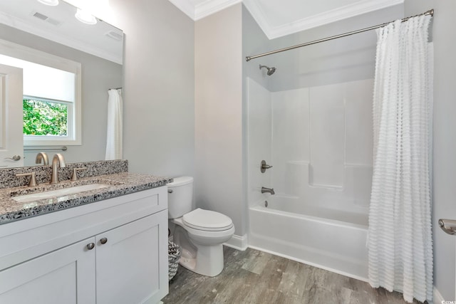 bathroom featuring toilet, visible vents, wood finished floors, and ornamental molding