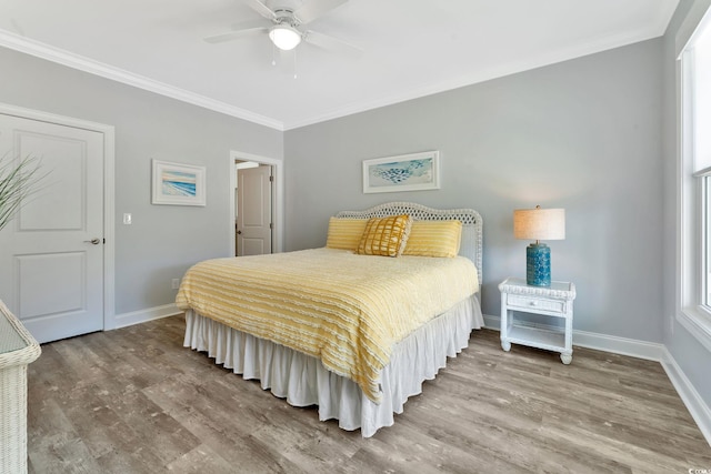 bedroom featuring ornamental molding, ceiling fan, baseboards, and wood finished floors