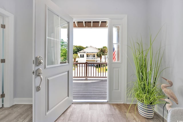 entryway with baseboards and wood finished floors