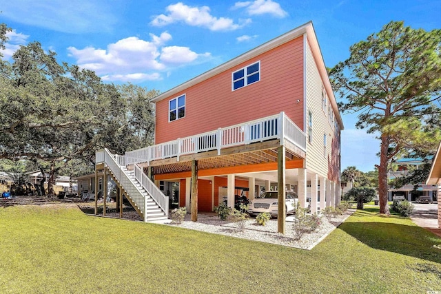 rear view of property featuring stairs, a lawn, and a wooden deck