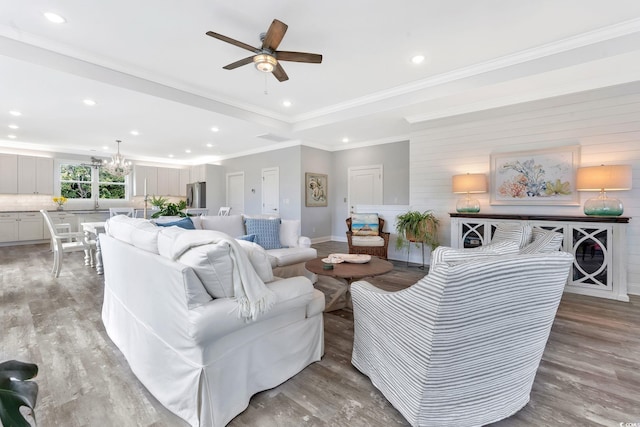 living area featuring light wood finished floors, visible vents, crown molding, and recessed lighting