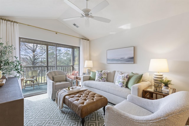 living area featuring lofted ceiling, visible vents, and ceiling fan