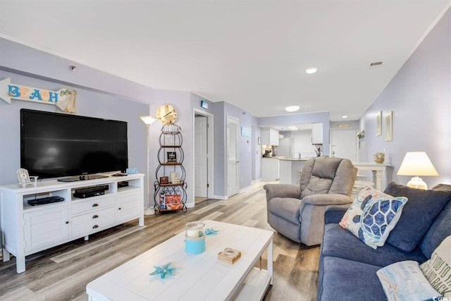 living area with baseboards and light wood-style floors