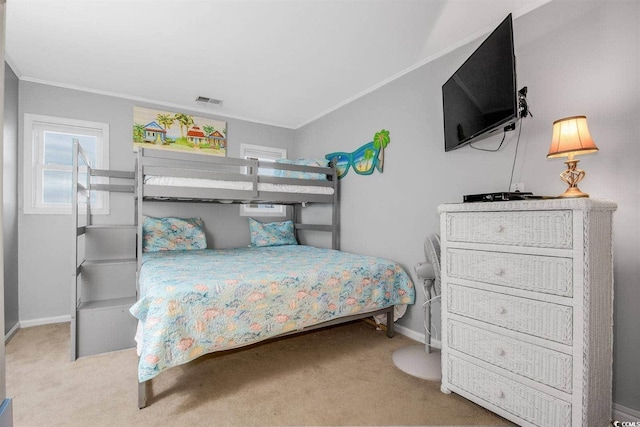 carpeted bedroom with visible vents, baseboards, and ornamental molding