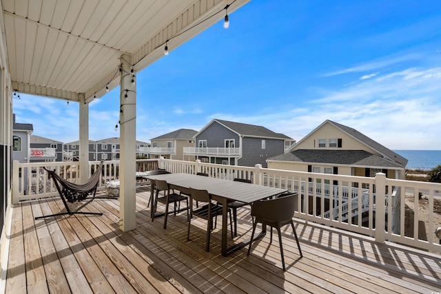 wooden deck featuring a residential view and a water view