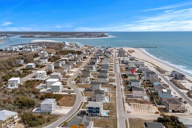 birds eye view of property with a beach view and a water view