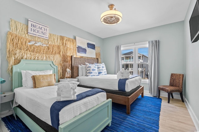 bedroom featuring wood finished floors and baseboards