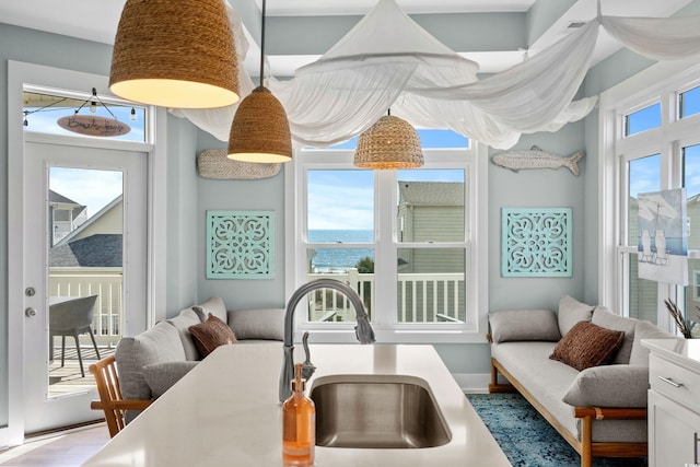 sunroom featuring plenty of natural light and a sink