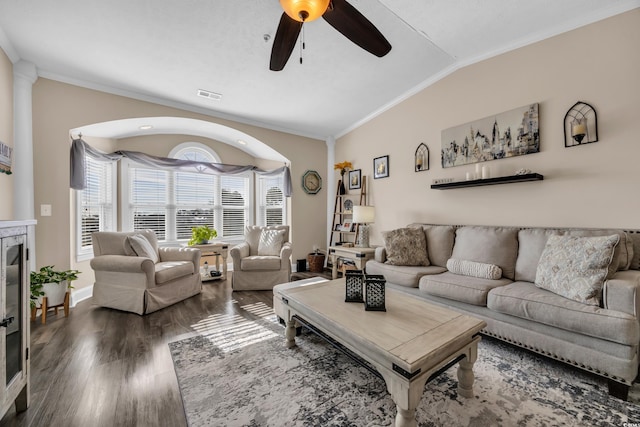 living room with lofted ceiling, ornamental molding, dark wood-style flooring, and visible vents