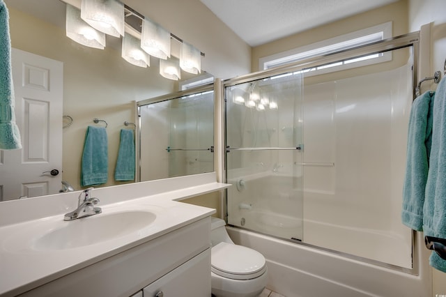 bathroom featuring vanity, toilet, and bath / shower combo with glass door