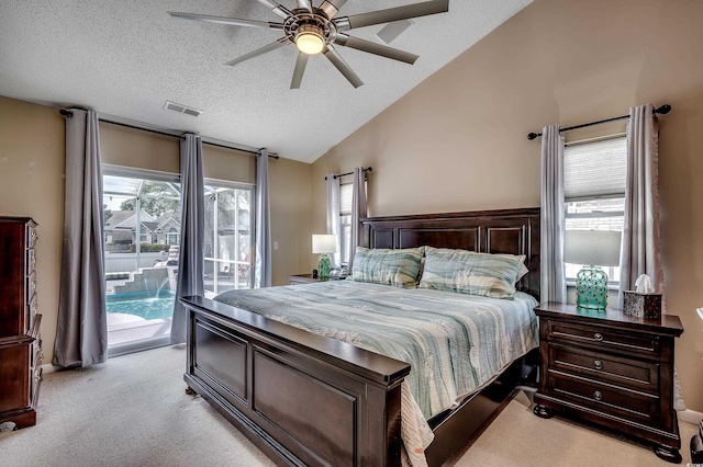 bedroom with access to exterior, visible vents, light carpet, vaulted ceiling, and a textured ceiling