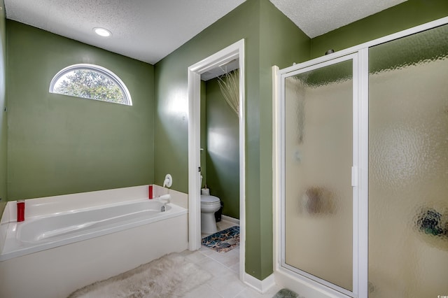 full bathroom featuring a textured ceiling, toilet, a stall shower, and a bath