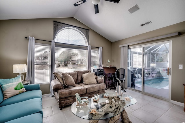 living room with light tile patterned floors, ceiling fan, visible vents, and vaulted ceiling