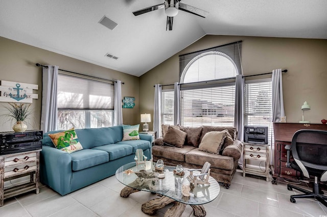 living room with a wealth of natural light, ceiling fan, lofted ceiling, and tile patterned floors