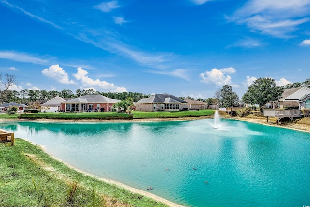 view of pool featuring a water view and a lawn