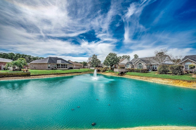 view of swimming pool with a water view, a residential view, and a yard