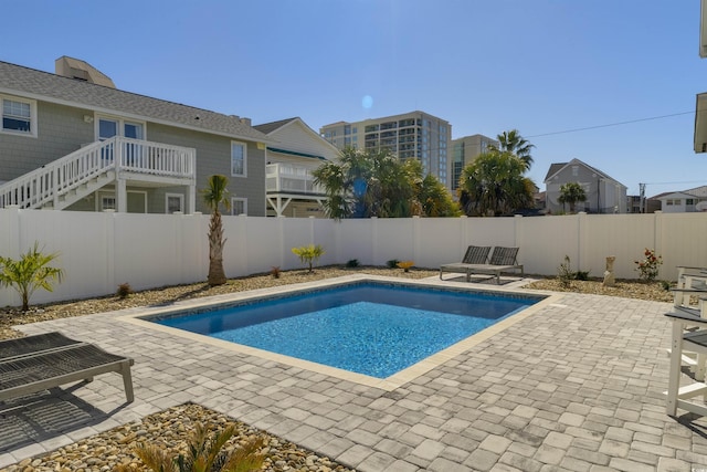 view of swimming pool with a fenced in pool, a patio, and a fenced backyard