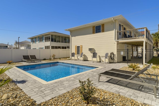 rear view of house featuring a patio area, a fenced in pool, and a fenced backyard