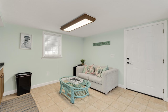 living area with light tile patterned floors and baseboards